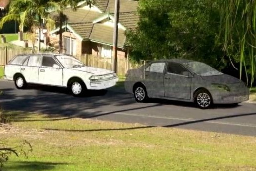 A suburban street with two illustrated cars.