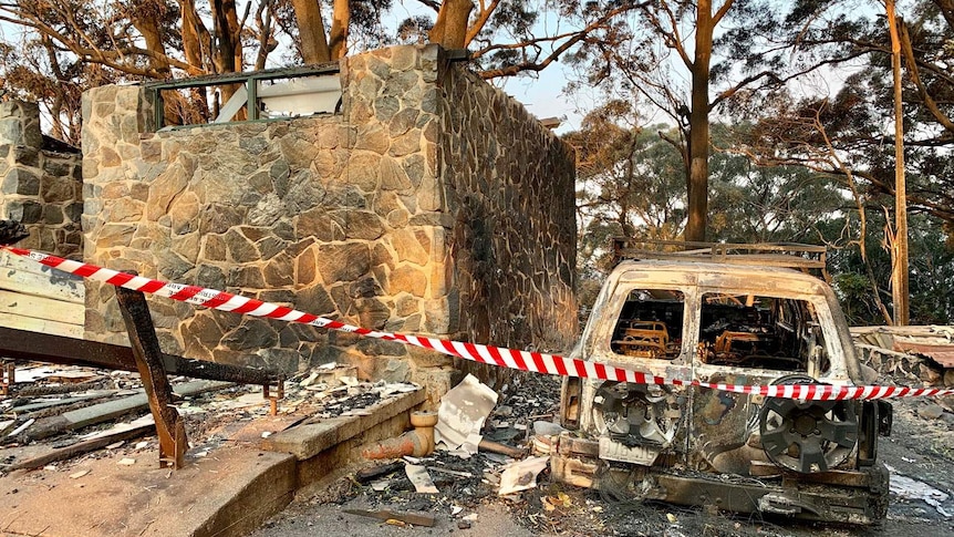 Destroyed vehicle and ruins of Binna Burra Lodge after bushfires in the Lamington National Park.