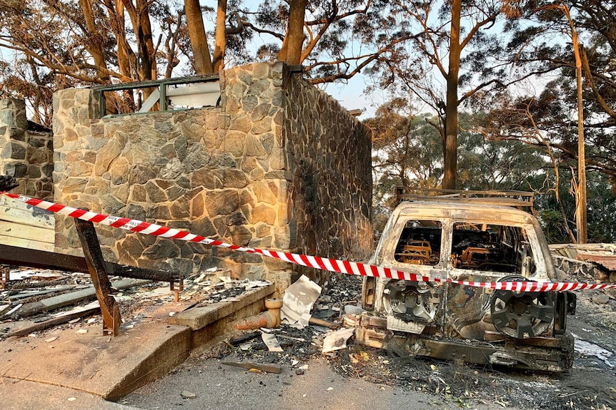 Destroyed vehicle and ruins of Binna Burra Lodge after bushfires in the Lamington National Park.