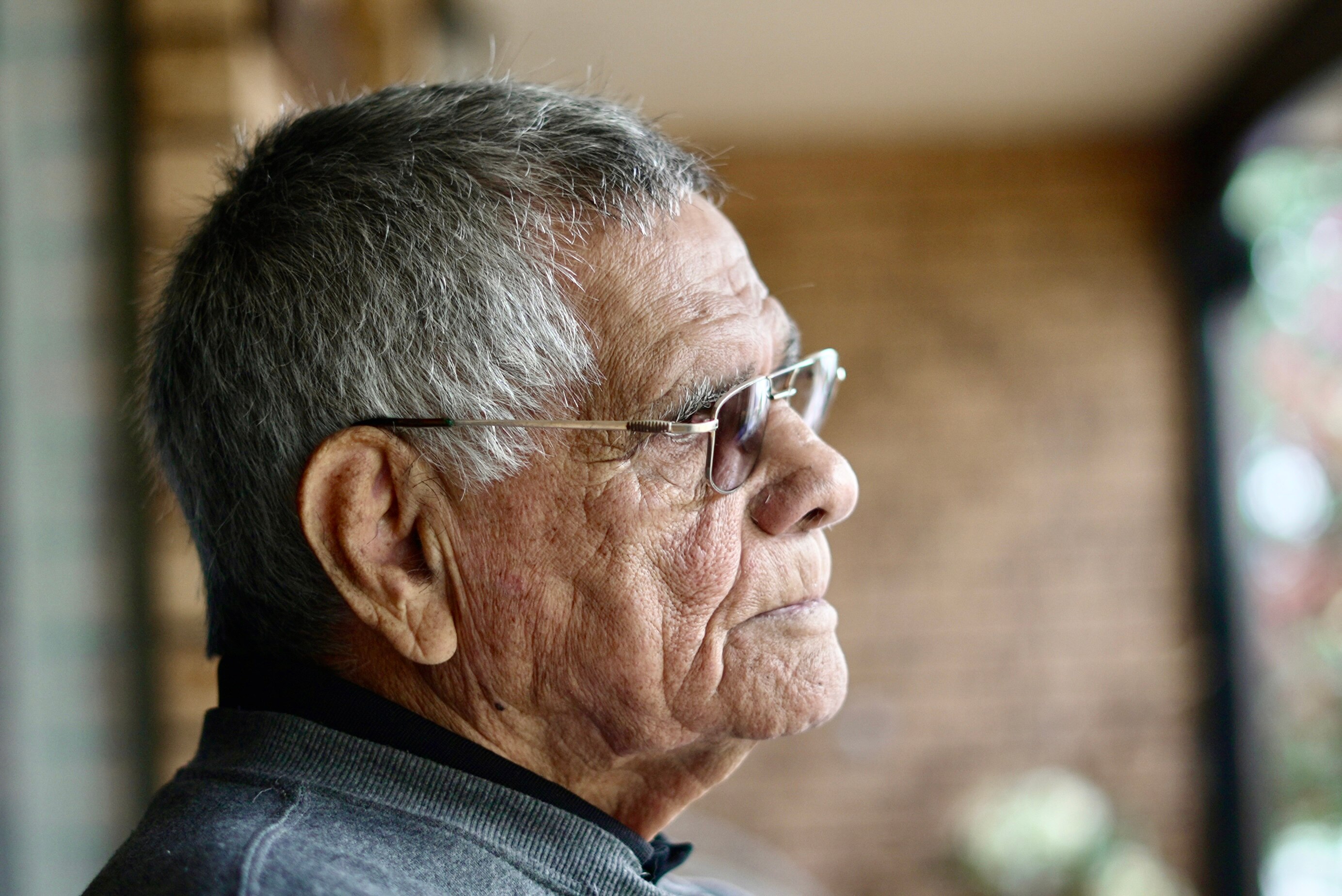 Close up of Johns side profile wearing glasses