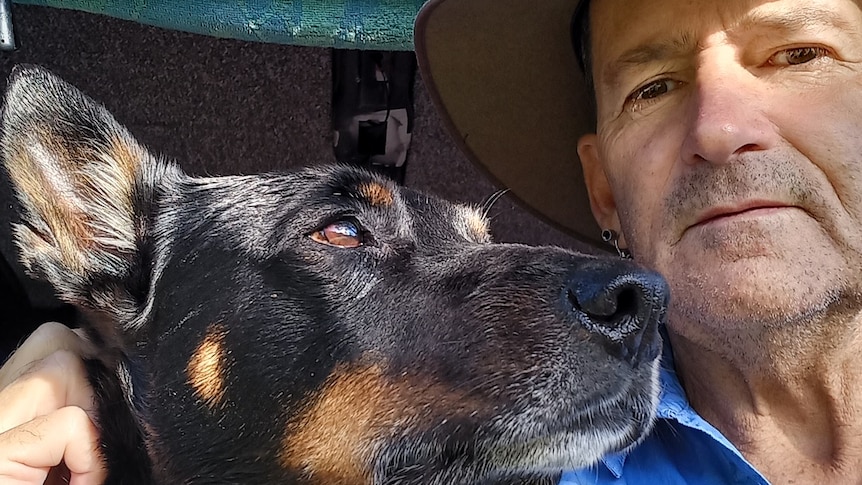Warren takes a selfie with him and his dog Driver