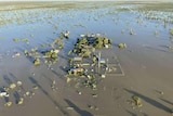 An aerial view of floodwaters inundating a tiny town