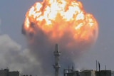 A fireball rises from an ammunitions factory in the Syrian city of Homs.
