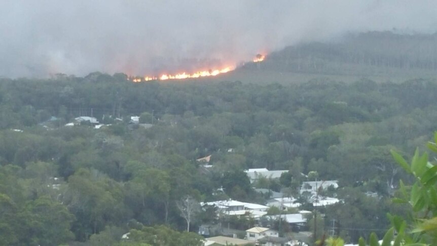 The Coolum fire approaches homes on Thursday afternoon.