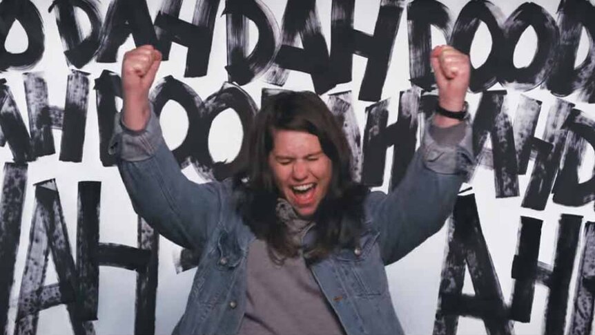 A screencap of Alex Lahey posing triumphantly from the 'I Haven't Been Taking Care Of Myself' video