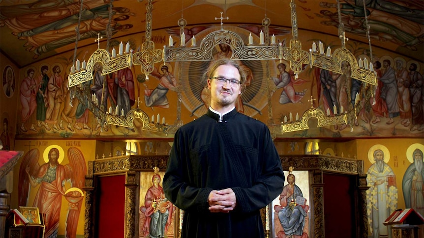 Father Branko Bosoncic stands inside the St John the Baptist Serbian orthodox Church in Wollongong.