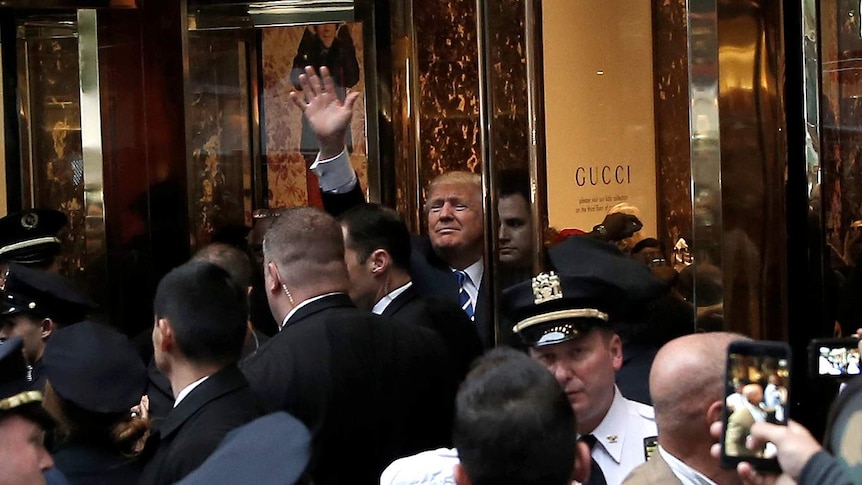 Donald Trump waves to supporters outside the front door of Trump Tower on fifth avenue.
