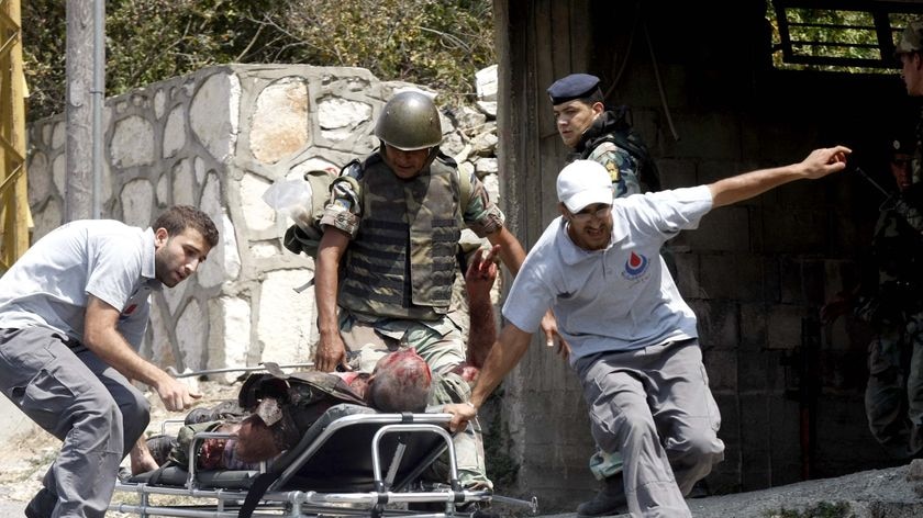 Rescue workers in Adaisseh evacuate a Lebanese army soldier wounded in clashes