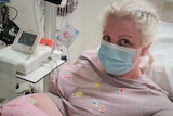 A pregnant woman in a hospital bed