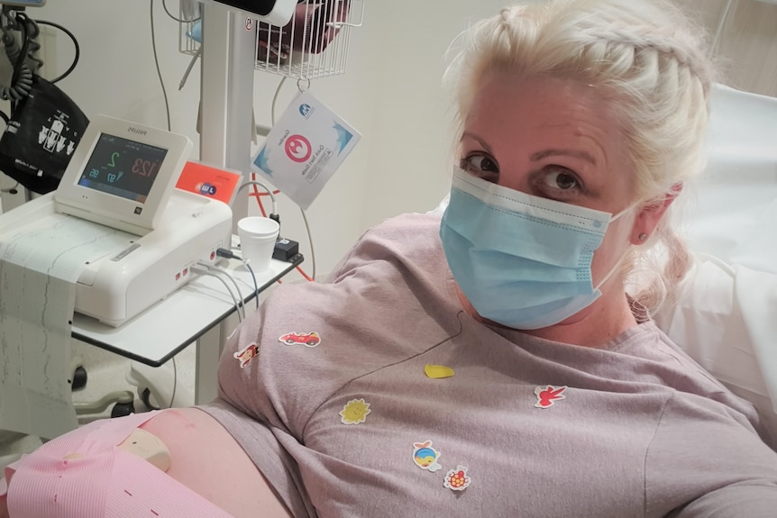 A pregnant woman in a hospital bed