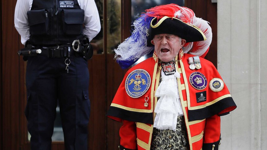 Unofficial town crier stands on the steps of St Mary's Hospital announcing the birth of a royal baby son.