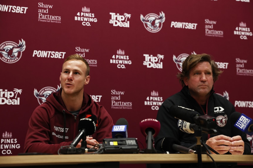 Daly Cherry-Evans speaks while sitting next to Des Hasler at a press conference