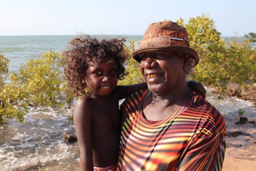 A man holding his nephew's daughter.