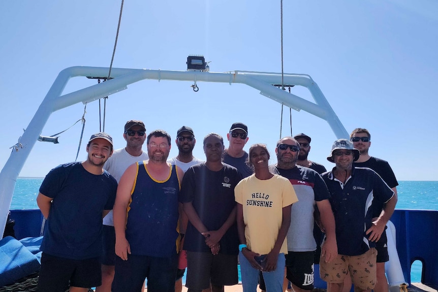 DPIRD staff and Warrwa community members stand together on boat. 