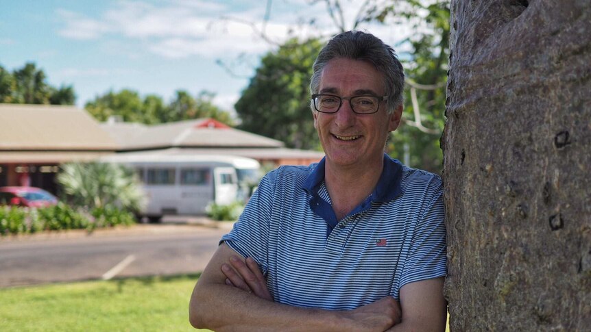 Chris Mitchell leans against a tree in Kununurra in the north of Western Australia.