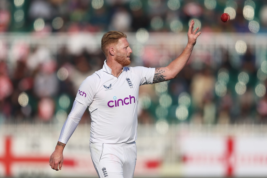 Ben Stokes holds up his left hand to catch the ball