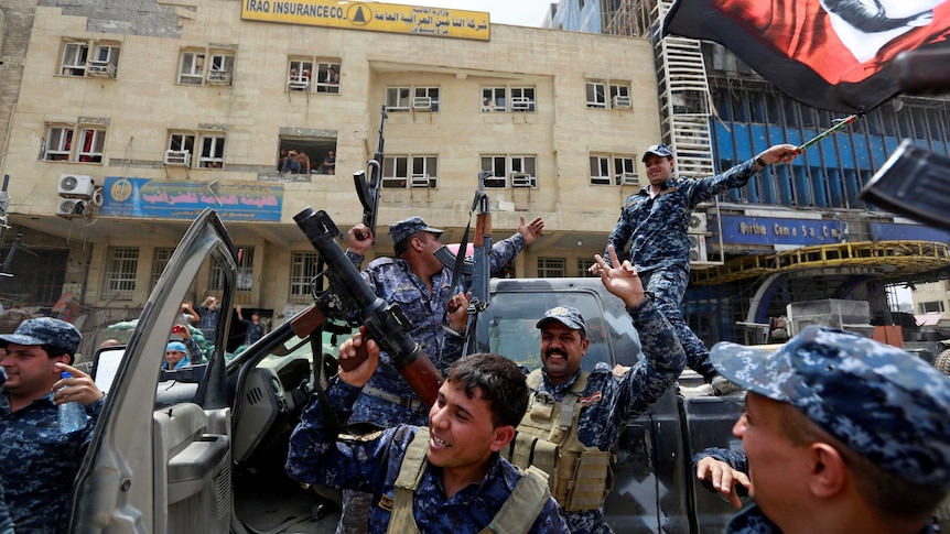 Iraqi Federal Police celebrate in the Old City.