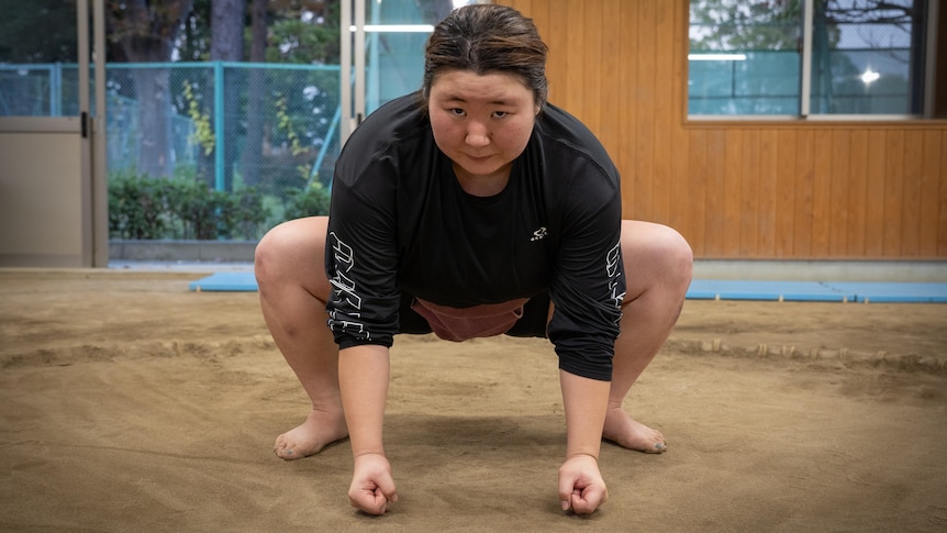 A woman in shorts crouched down 