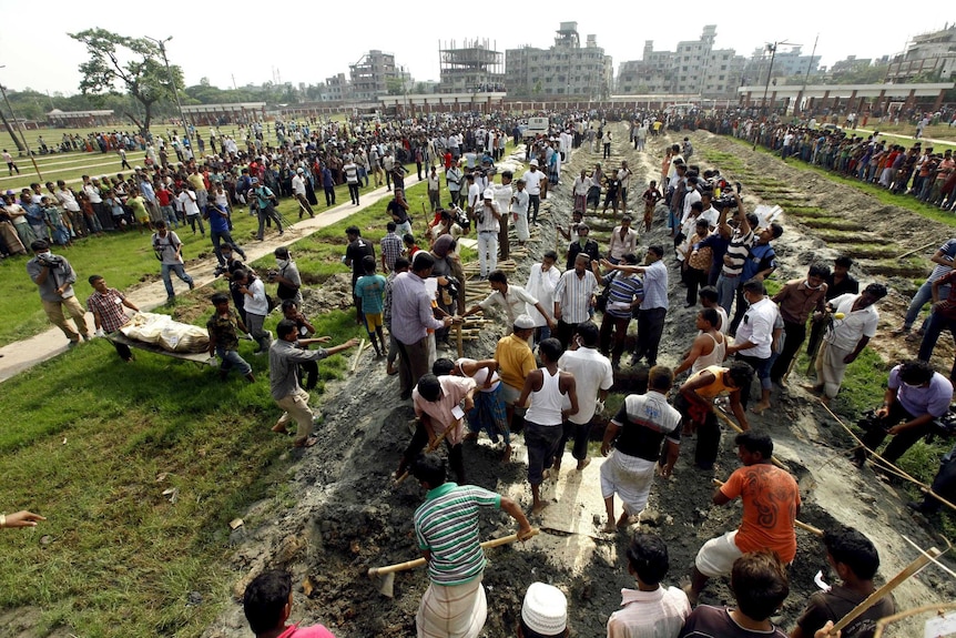 Bangladeshis bury the remains of garment workers killed in the garment factory collapse.