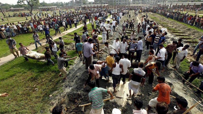 Bangladeshis bury the remains of garment workers killed in the garment factory collapse.