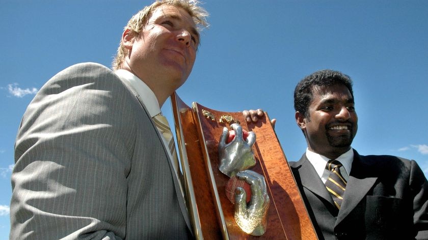 Smile for the cameras ... Shane Warne and Muttiah Muralidaran unveil the new trophy named in their honour