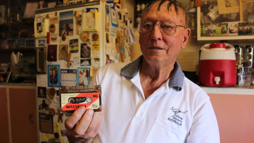 Alan Boyle sits at his kitchen table holding his original recording of Prince Charles at Beverley, Western Australia.