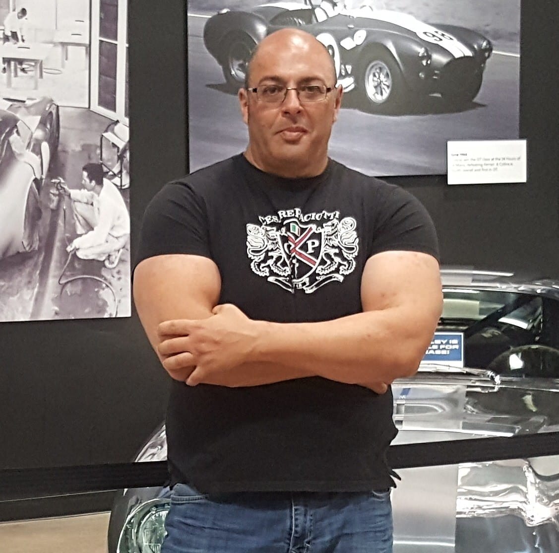 A man stands with his arms crossed.