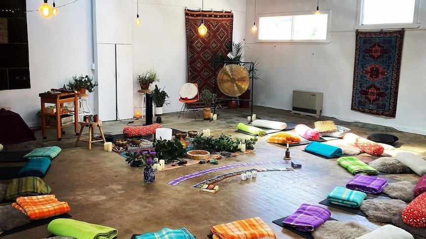 A large room filled with cushions placed in a circle.