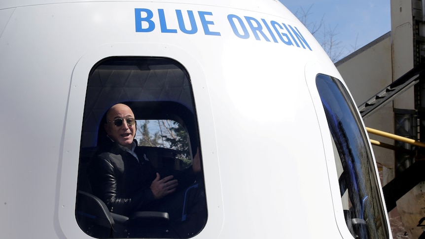 Amazon and Blue Origin founder Jeff Bezos sist in the cockpit of an aircraft.