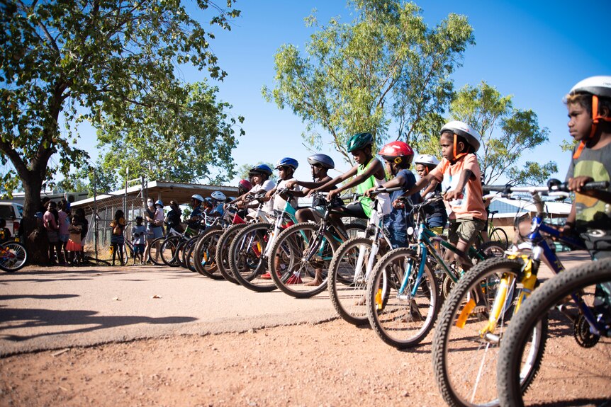 Students line up with their bikes in the community of Yarralin. 