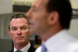 Education Minister Christopher Pyne in focus, PM Tony Abbott out of focus