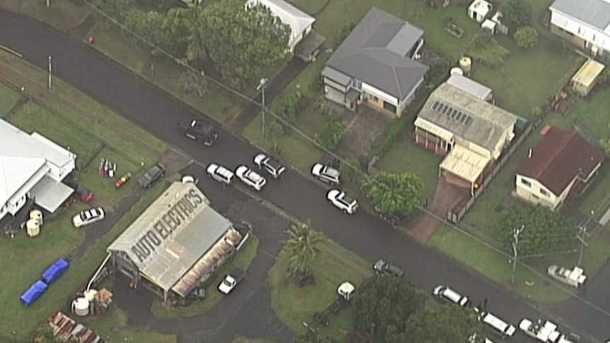 An aerial photo of the site of the siege, a number of cars outside a property.