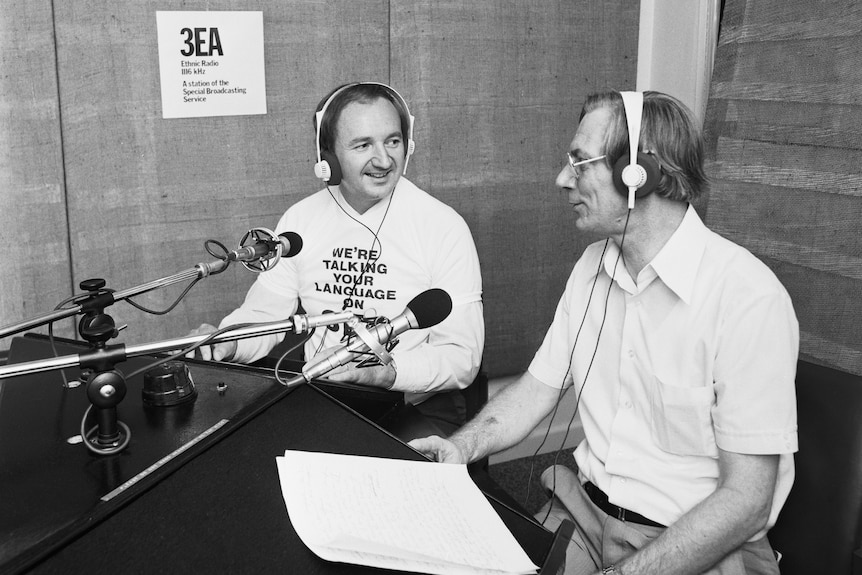 A black and white photo of two men in a radio booth