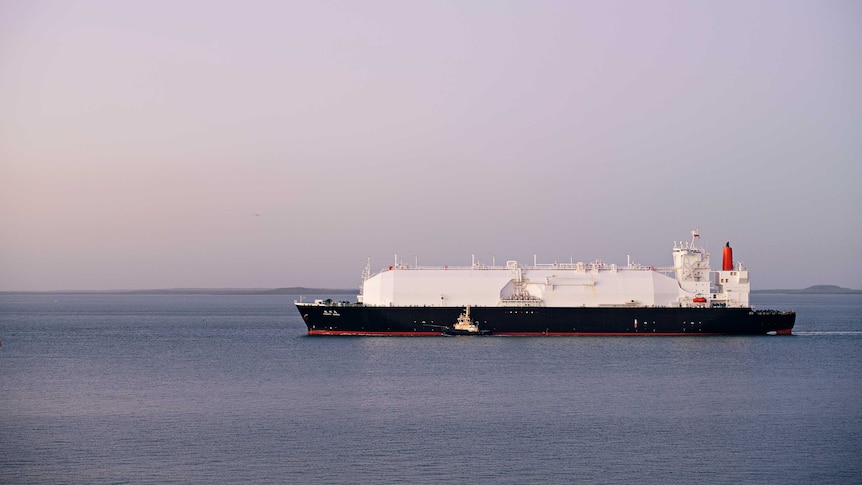 a large LNG ship in a harbour.