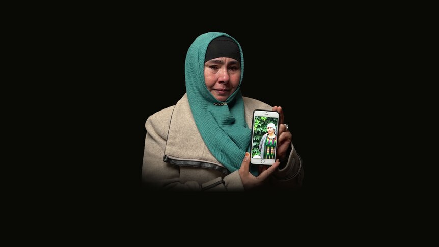 Horigul Yusuf, 53, holds a photo of her missing sister.