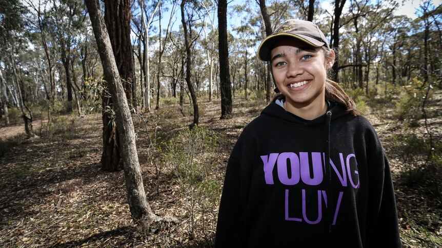 Annalise Varker, 15, smiling in a bush setting at greater Bendigo National Park.