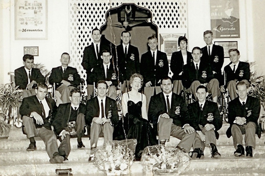 Paralympians pose with an entertainer at their hotel in Singapore en route to the first Paralympic Games in Rome.