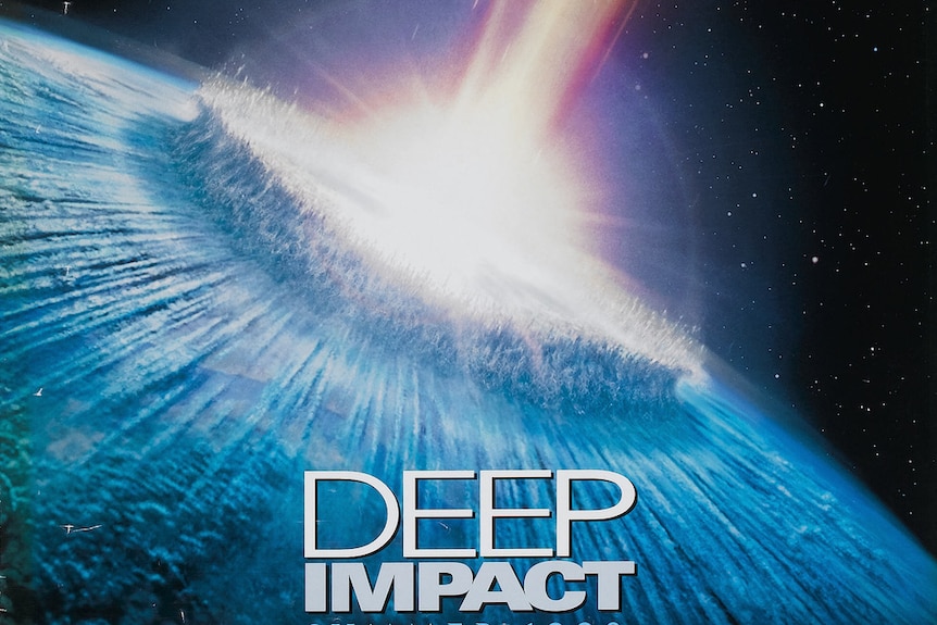 A promotional poster for the 1998 film Deep Impact showing an asteroid crashing into Earth