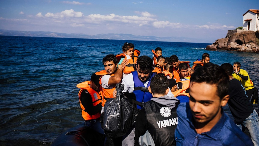 People arrive by boat on the Greek island of Lesbos