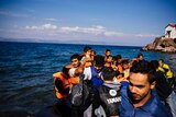 People arrive by boat on the Greek island of Lesbos