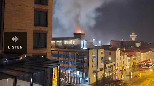 Flames and smoke as a fire burns on a rooftop . Has Audio.