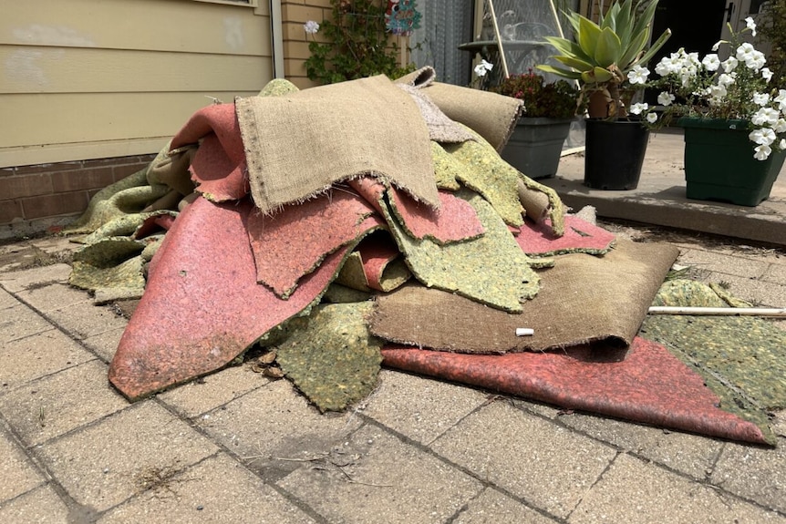 A stack of carpet is piled up on the front porch of a house in Kerang in northern Victoria.