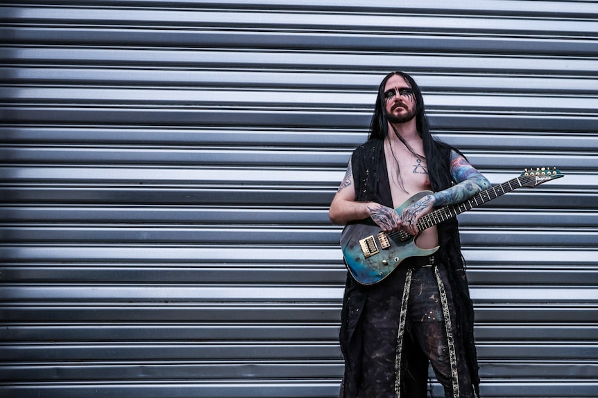Guitarist from Metal band Scaphis standing outside
