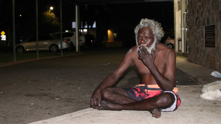 Homeless Aboriginal man sits on a Darwin street