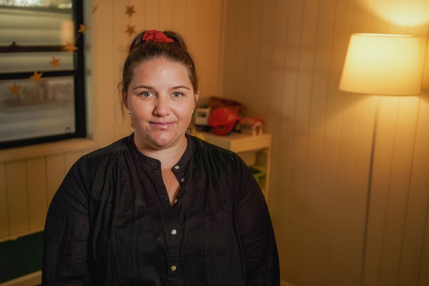 A woman stands in a child's toyroom.