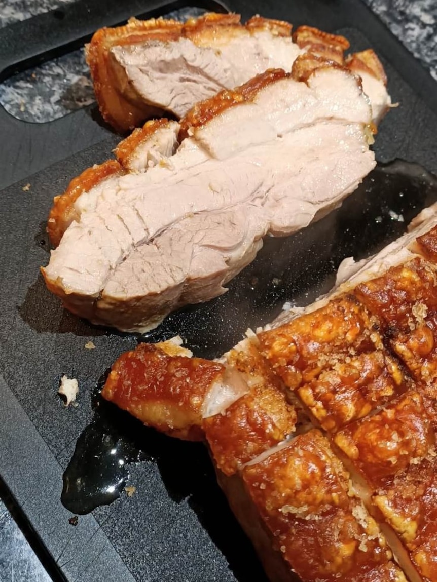 A roast pork belly, sliced open into pieces.