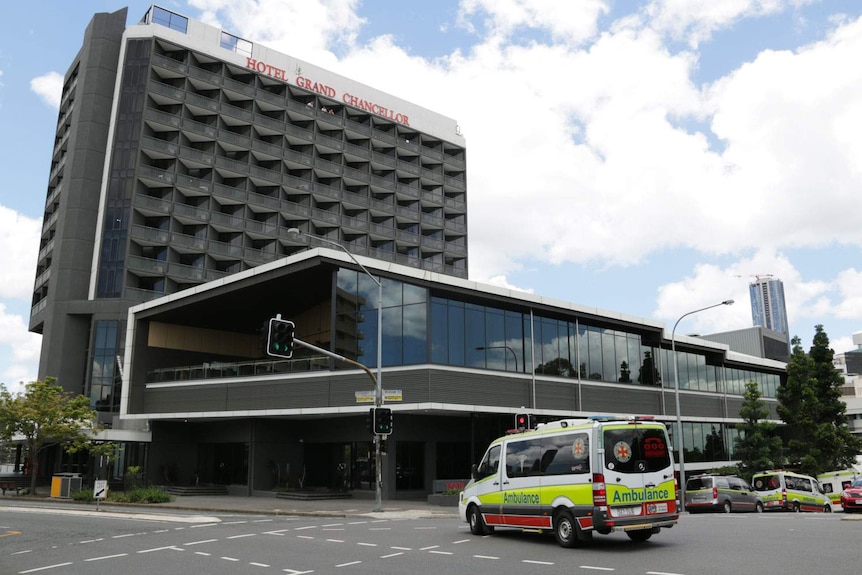 Hotel Grand Chancellor at Spring Hill in inner-city Brisbane with several ambulances parked outside and driving in the street.