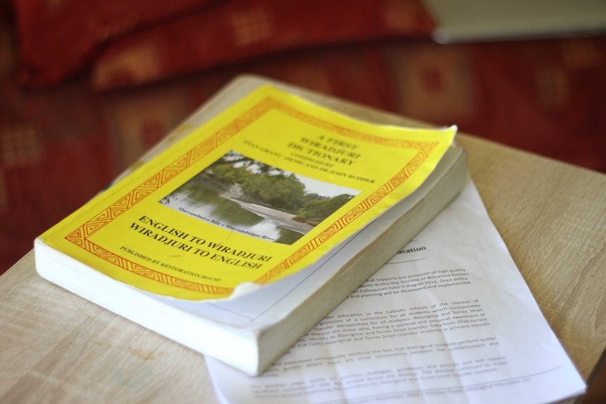 A well-thumbed English-Wiradjuri/Wiradjuri-English dictionary on a table.