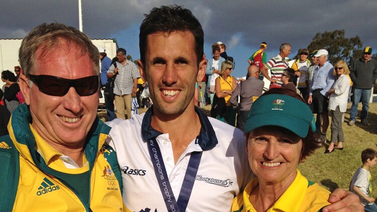 Australian hockey player Mark Knowles hugs his parents, while wearing a gold medal
