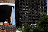 A man looks across to Grenfell Tower from his balcony.